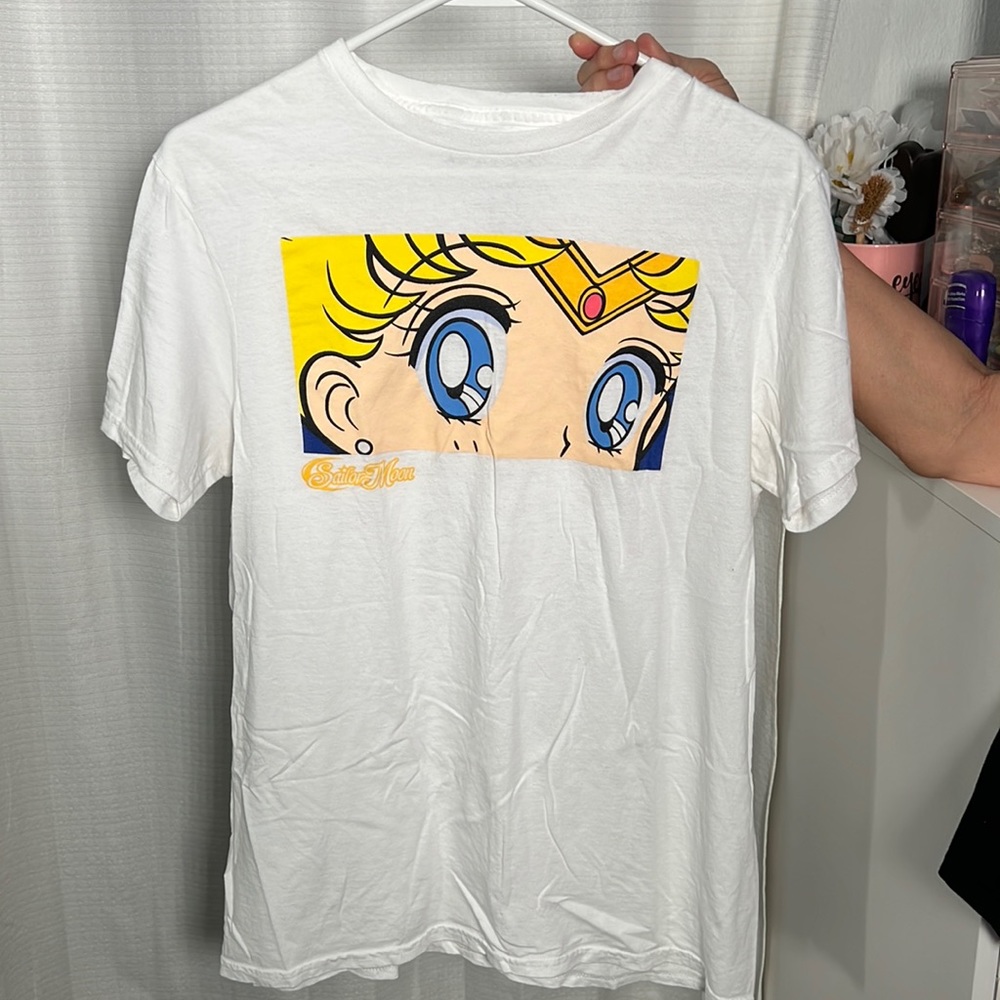 White shirt with sailor moon print. 90’s babes will love.